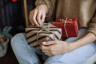 Midsection of woman holding ice cream in box