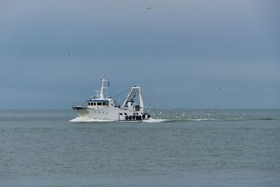 Scenic view of fishing boat against sky