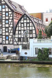 Arch bridge over river against buildings in city