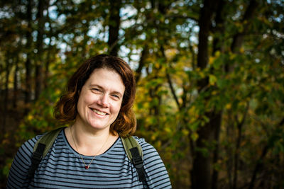 Portrait of smiling woman in forest