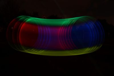 Close-up of illuminated lighting equipment against black background