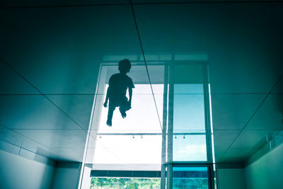 Reflection of boy on floor