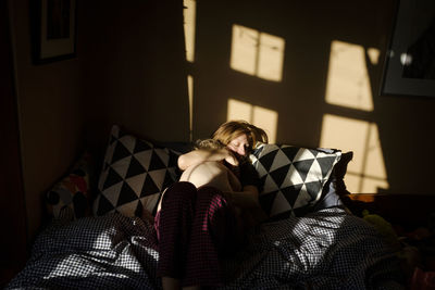 Woman sitting on sofa at home