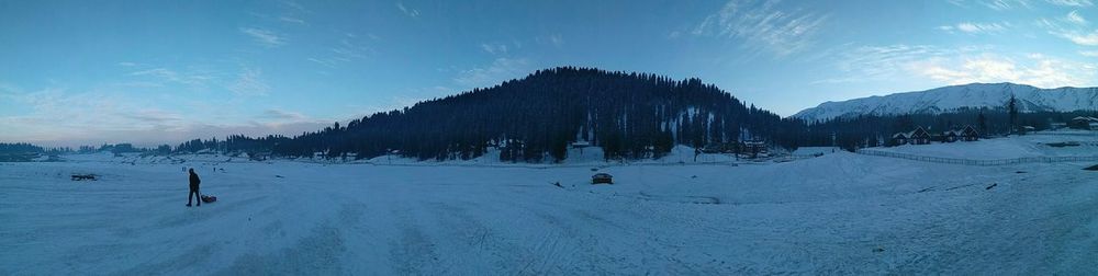 Panoramic view of snow covered mountain against sky