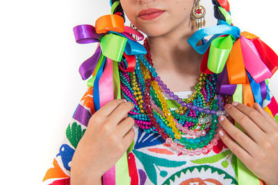 Midsection of woman holding multi colored umbrella