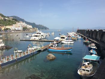 Boats moored at harbor against sky, greece 