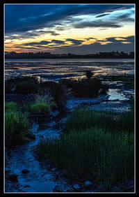 Scenic view of lake at sunset