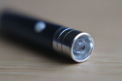 Close-up of small flash light on table