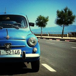 Cars on road against blue sky