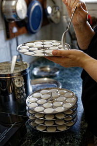 Midsection of person preparing food in kitchen