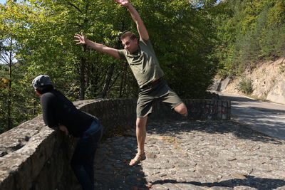 Full length of young man jumping on tree