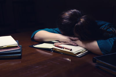 Young woman sitting on table