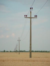 Electric poles on countryside landscape