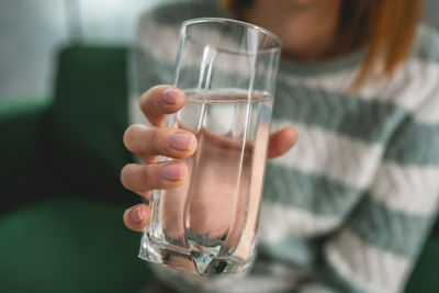 Midsection of woman holding drink