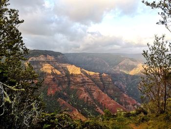 Scenic view of landscape and canyon against sky