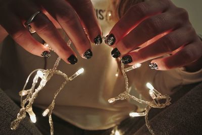 Woman holding christmas lights