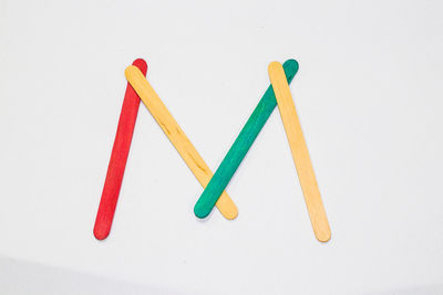 High angle view of colored pencils against white background