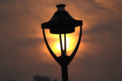 Low angle view of street light against sky during sunset