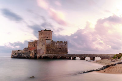 Castle in sea during sunset at lazio