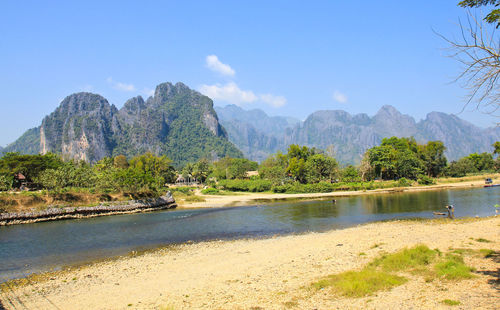 Scenic view of lake and mountains against sky