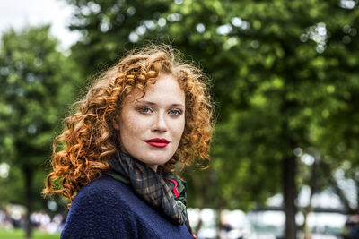 Portrait of redheaded young woman with red lips