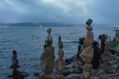 Rocks on sea shore against sky