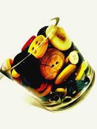 Close-up of fruits in bowl over white background