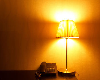 Close-up of illuminated electric lamp at home