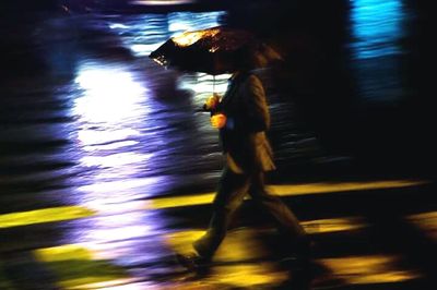 Blurred motion of woman at night