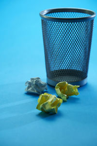 Close-up of garbage bin on table