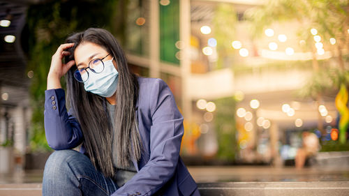 Businesswoman stressed from finding the new job, unemployed while sitting in front of the office,