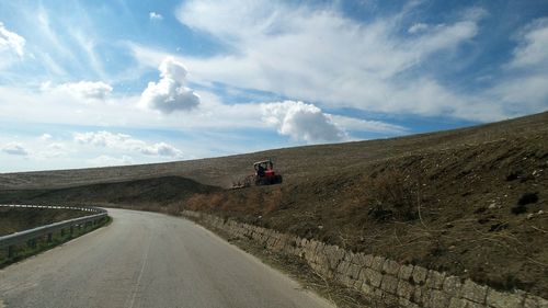 Empty road along countryside landscape