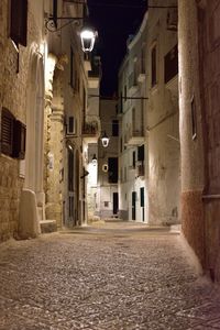 Street amidst buildings in town at night