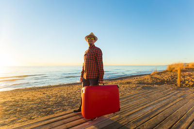 Man on beach against clear sky