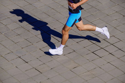 Low section of woman walking on footpath