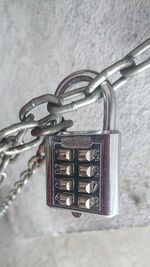 Close-up of padlocks hanging on metal chain