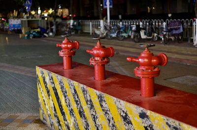 Close-up of fire hydrant on street in city at night