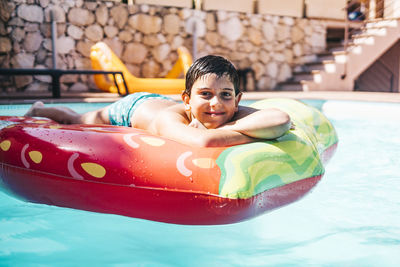 Two kids playing in a swimming pool