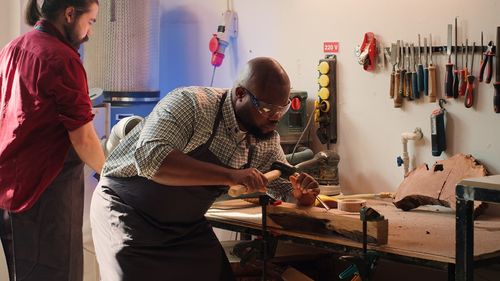 Rear view of man working in workshop