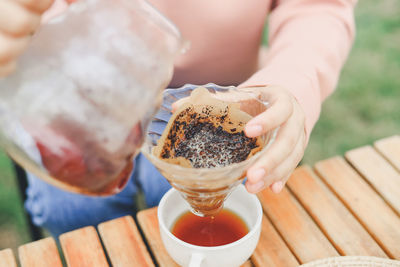 Midsection of woman holding coffee