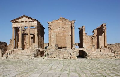 Low angle view of old ruin against clear blue sky