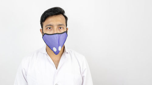 Portrait of young man against white background