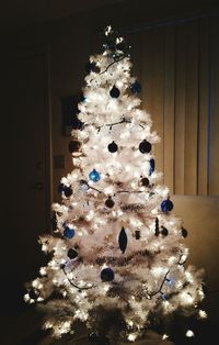 Close-up of illuminated christmas tree at home