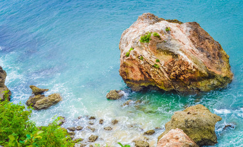 Rock formation in sea against sky