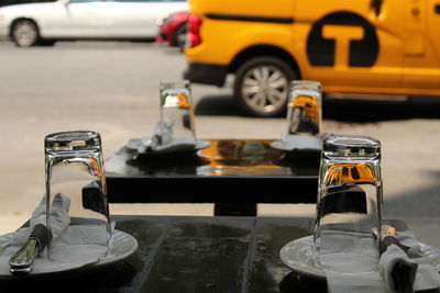 Drinking glasses with plates and cutleries arranged on tables