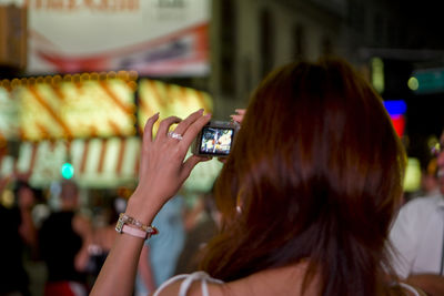 Woman photographing through smart phone