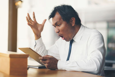 Mid adult man sitting at table