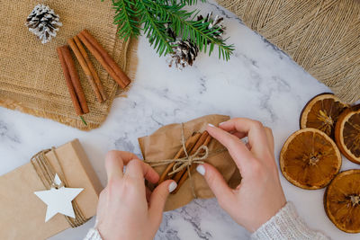 Cropped hands of person holding food on table