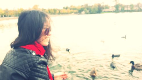 Rear view of girl standing at beach