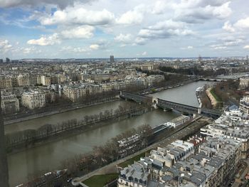 High angle view of river amidst buildings in city against sky